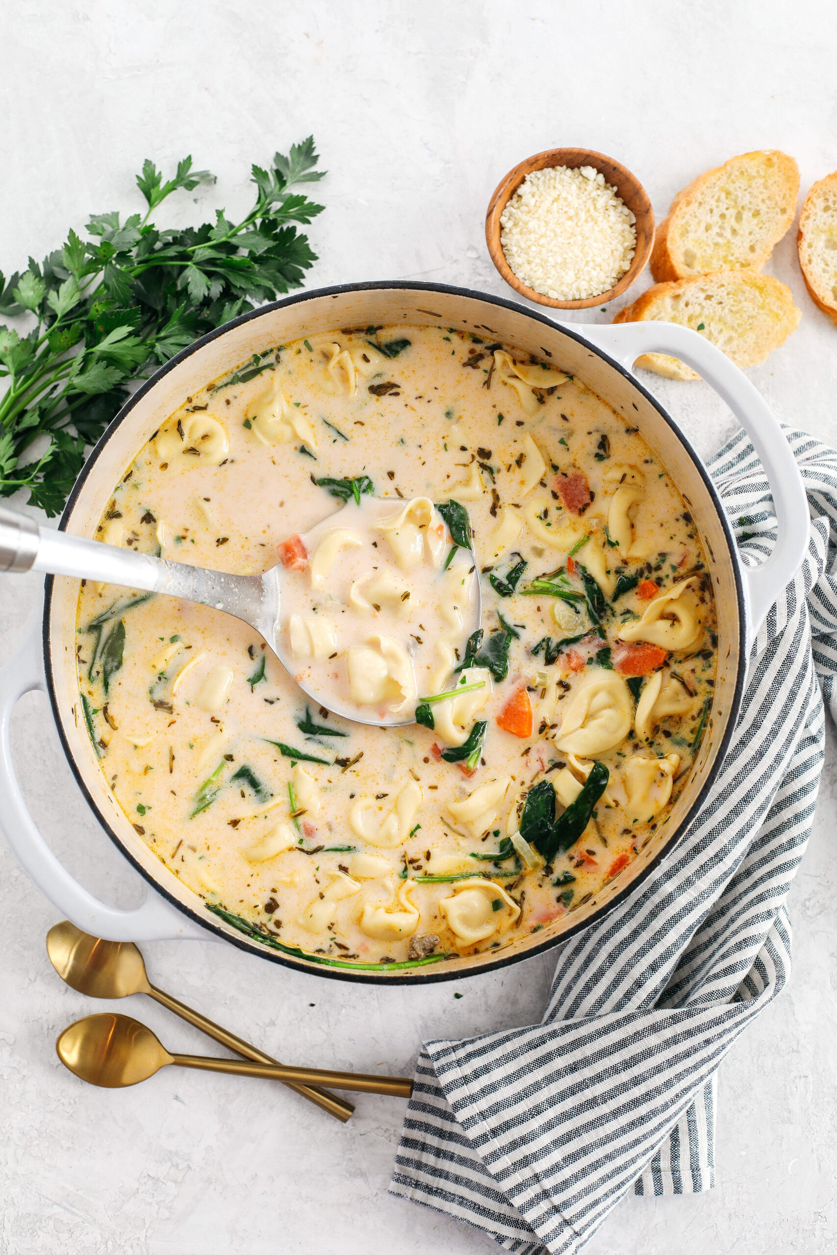 This Creamy Sausage & Spinach Tortellini Soup is delicious, loaded with veggies and makes the perfect cozy meal that can easily be made in your instant pot, slow cooker or right on the stove!