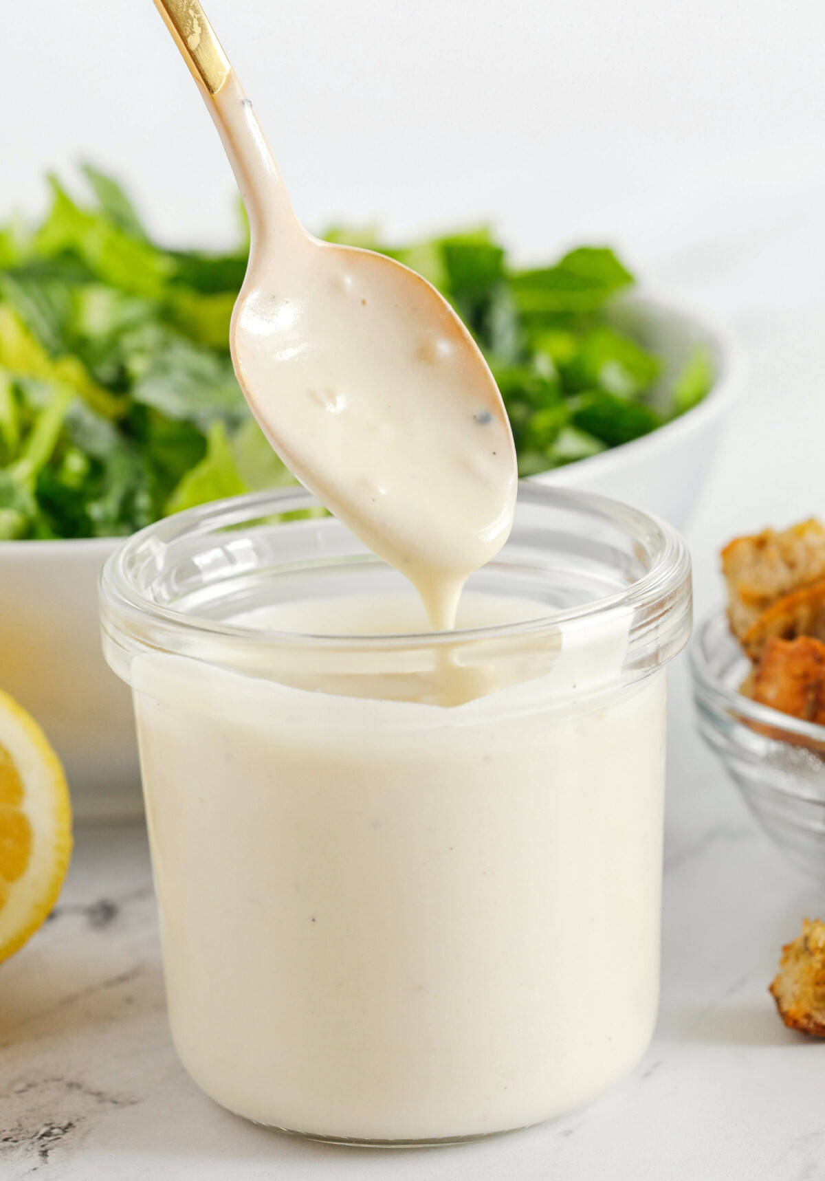 The BEST Healthy Chicken Caesar Salad made with grilled lemon chicken, garlicky homemade croutons, fresh parmesan cheese and tossed with a lightened up Greek yogurt dressing!