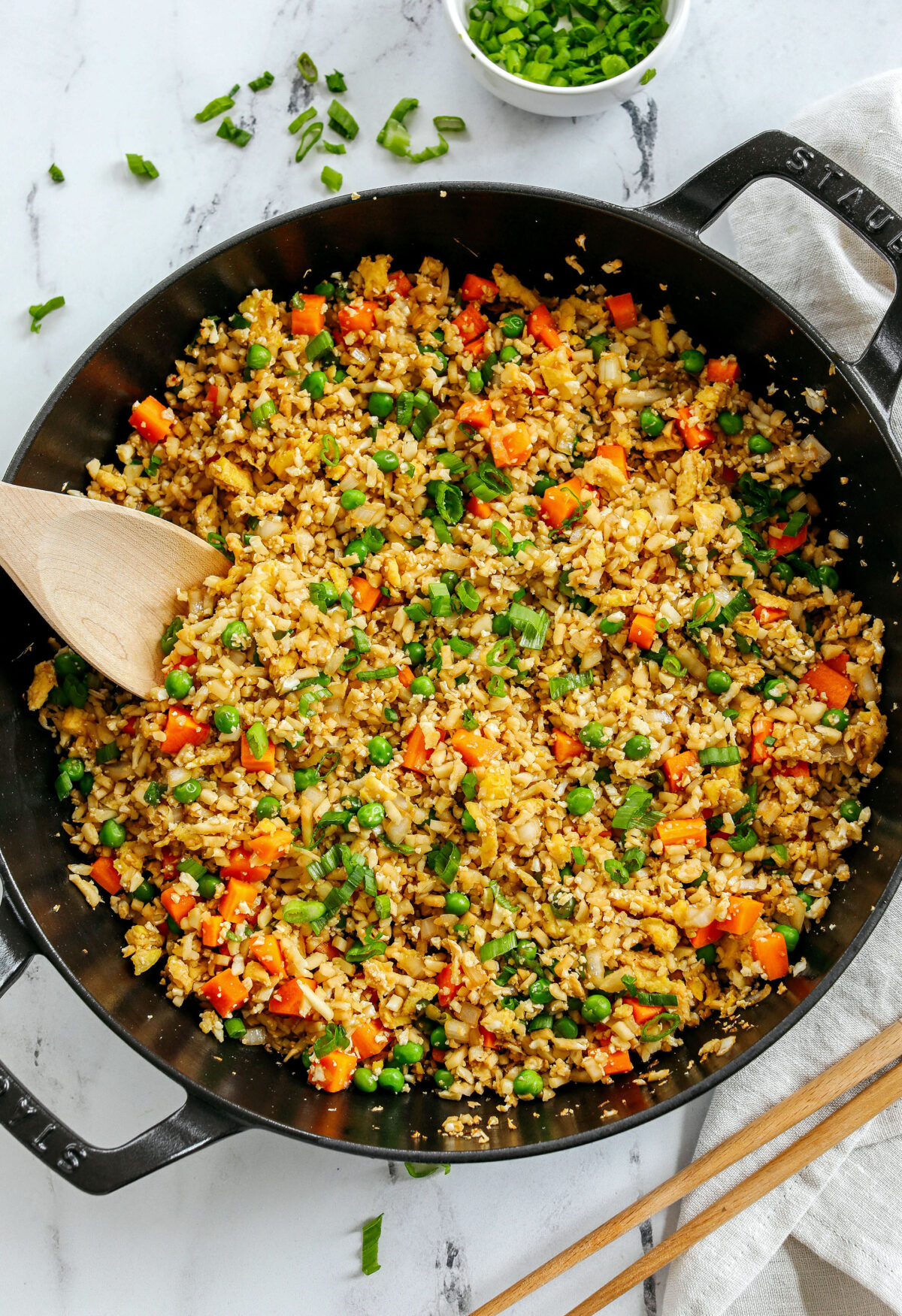 Skip the takeout and enjoy this Healthy Cauliflower Fried Rice in just 15 minutes!  Packed with veggies, low in carbs and can be served as a delicious side dish or a main dish with added protein!