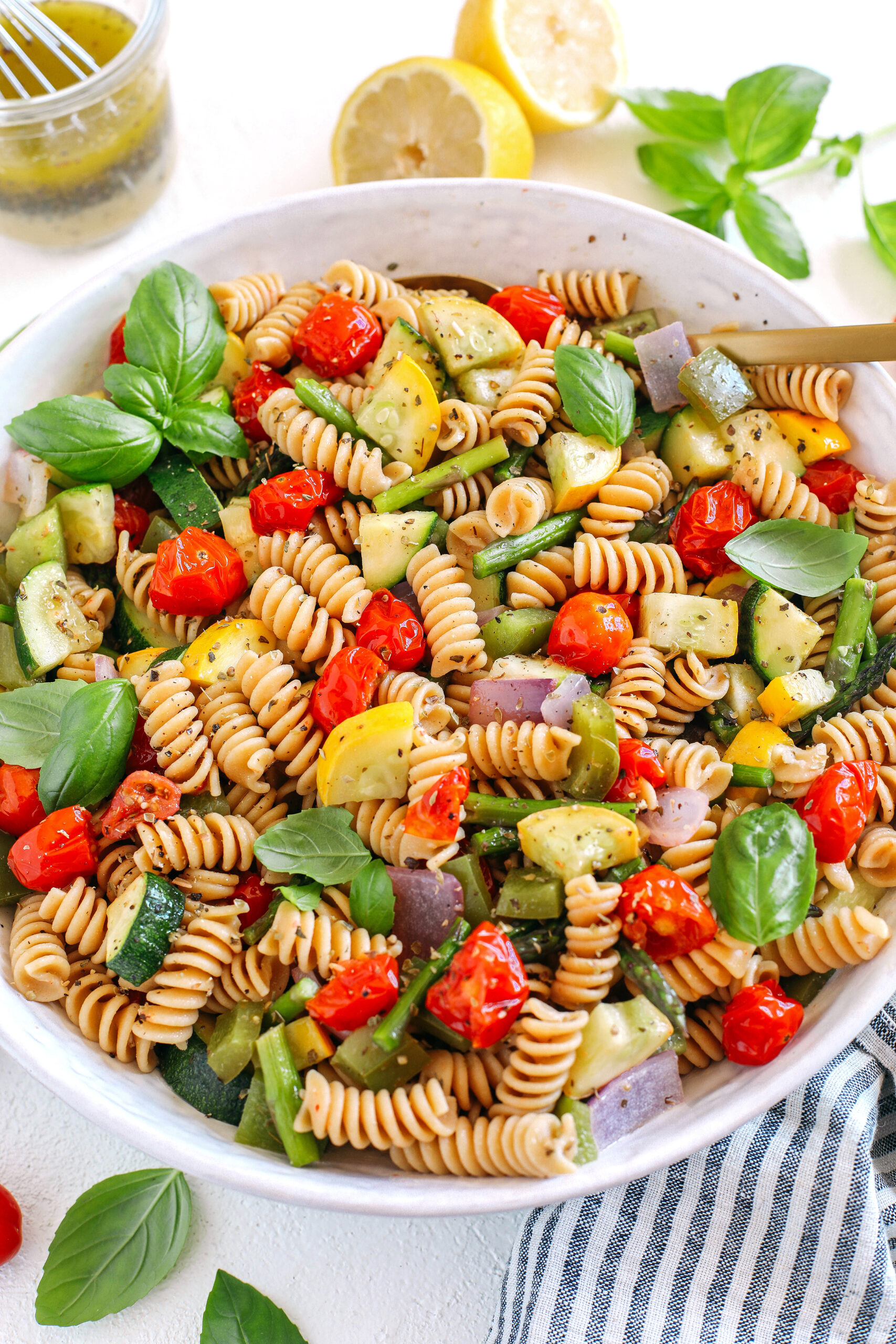 This EASY Roasted Veggie Pasta Salad is loaded with fresh ingredients like juicy tomatoes, zucchini, squash, asparagus, and bell pepper, all tossed together with a delicious lemon herb dressing!