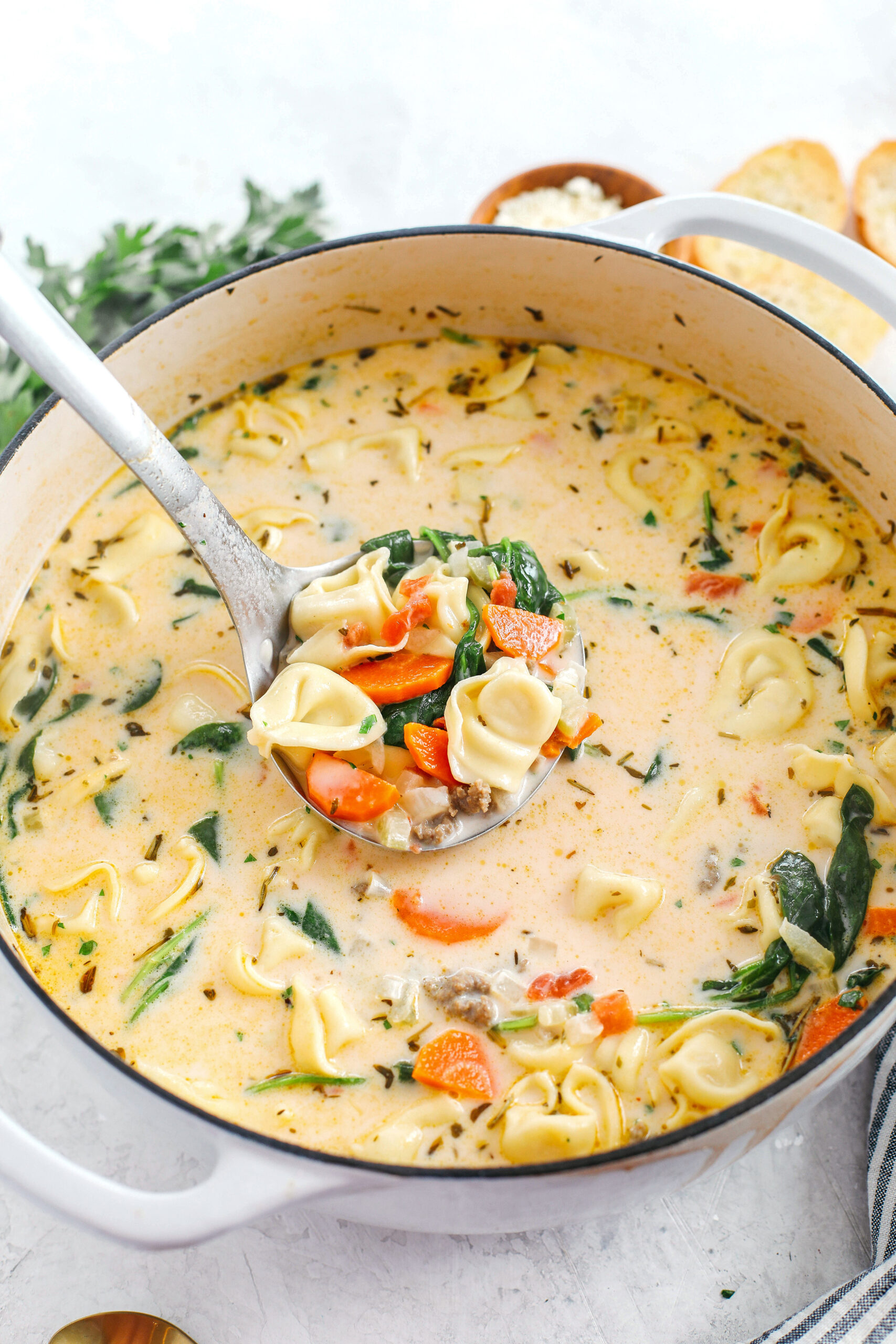 This Creamy Sausage & Spinach Tortellini Soup is delicious, loaded with veggies and makes the perfect cozy meal that can easily be made in your instant pot, slow cooker or right on the stove!